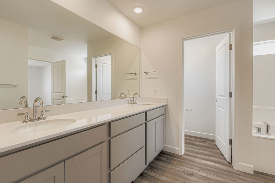 A bathroom with white cabinets.