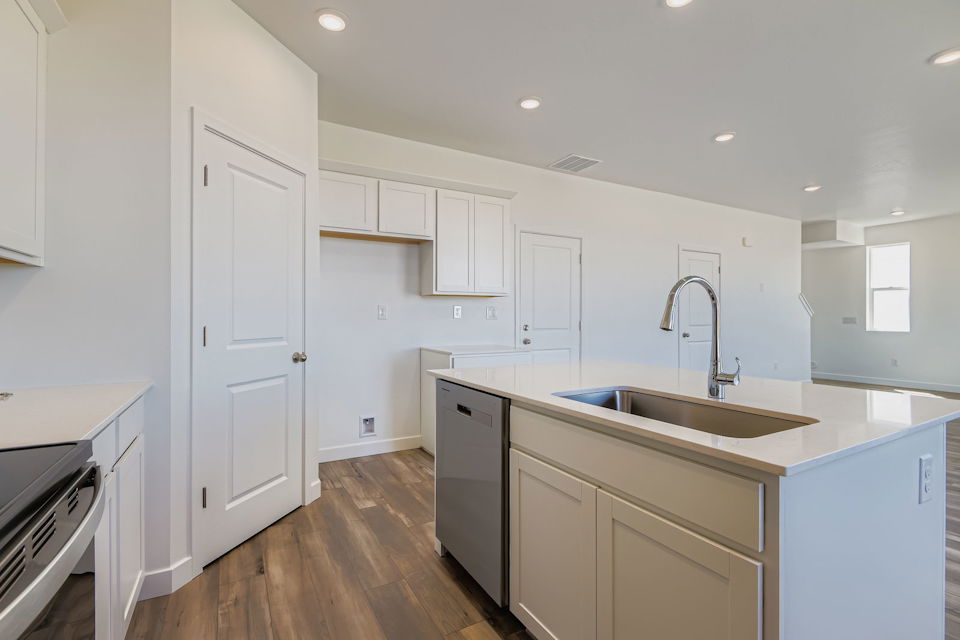 A kitchen with white cabinets.