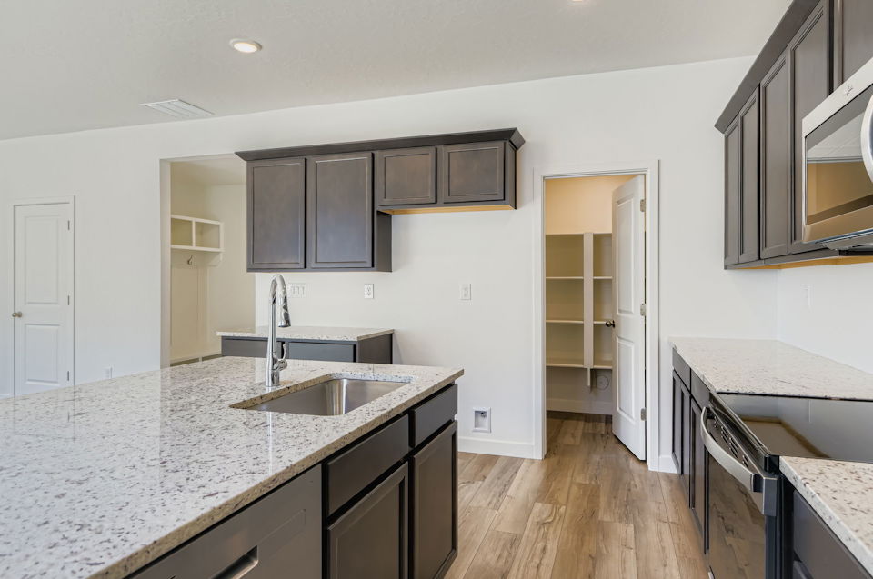 A kitchen with black cabinets.