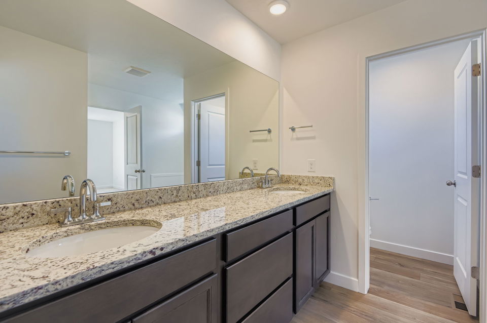 A bathroom with marble counter tops.