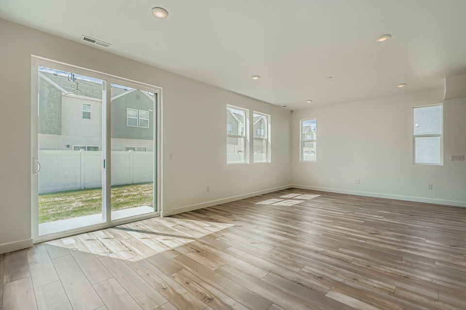A room with a wood floor and a glass door.