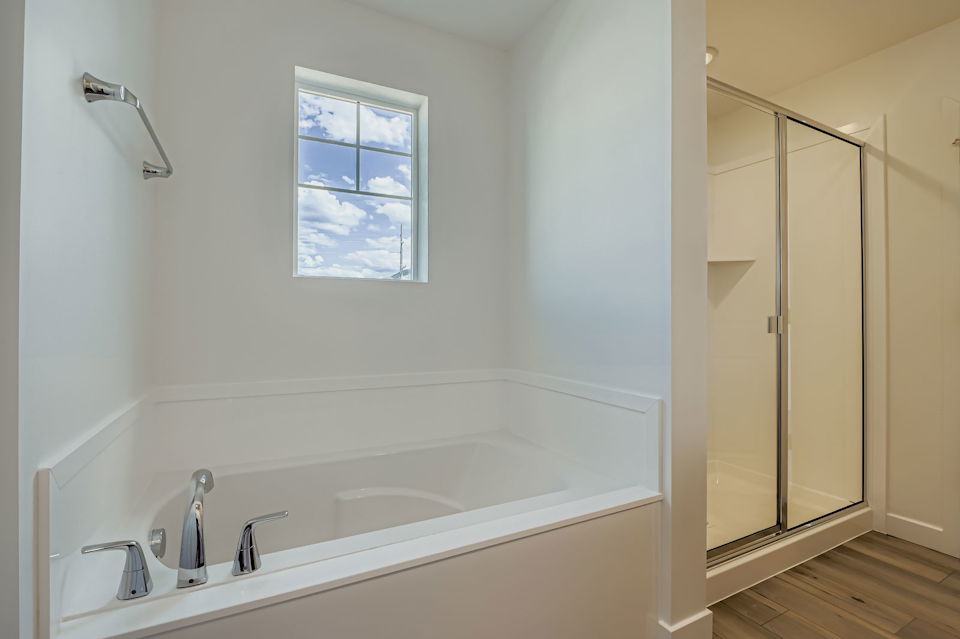 A bathroom with a tub and shower.