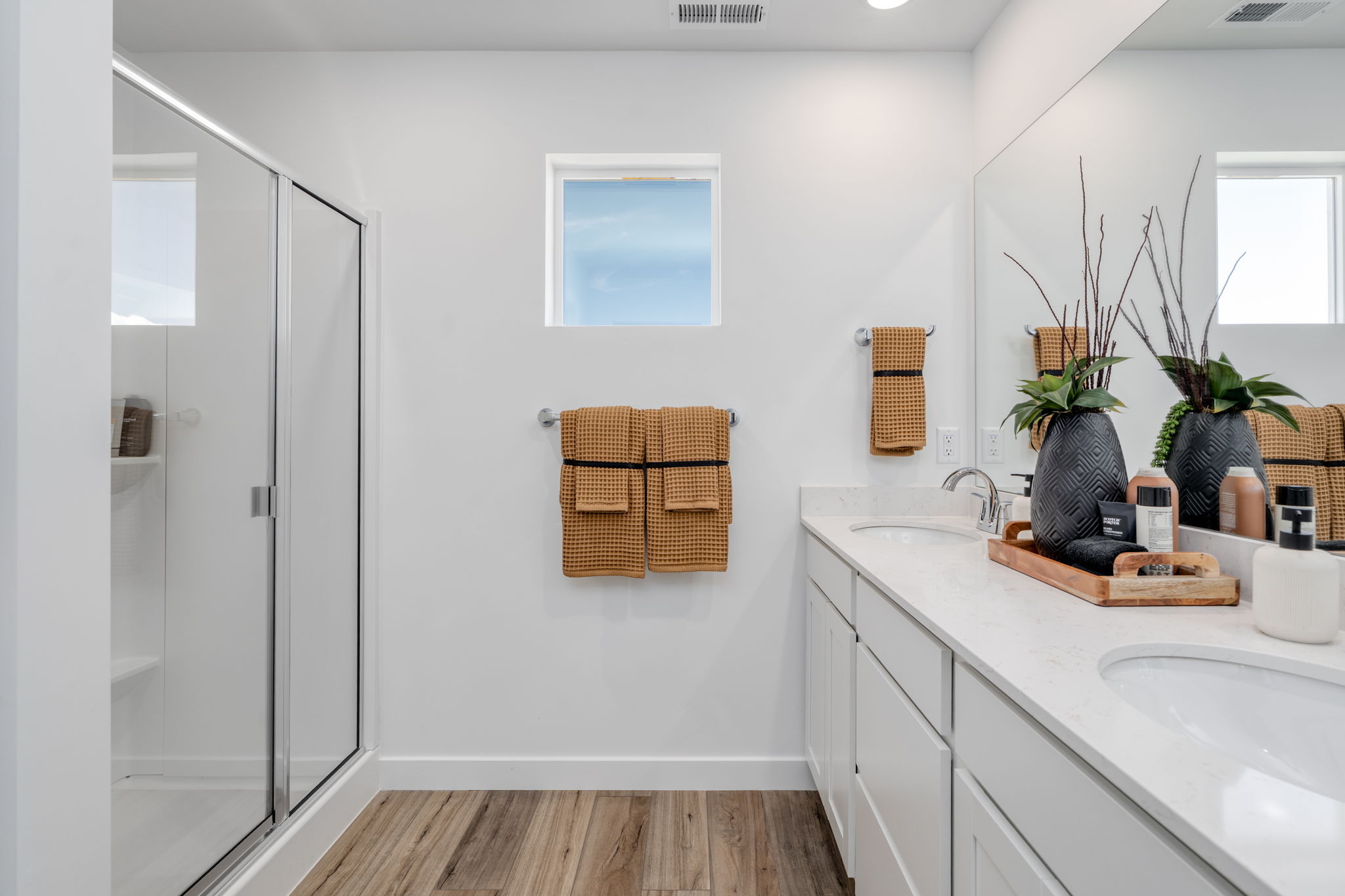 A bathroom with a sink and a shower.