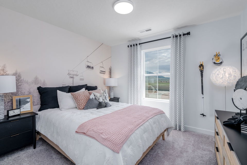 A bedroom with a bed and a window.