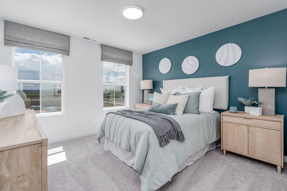 A bedroom with a bed and a window.