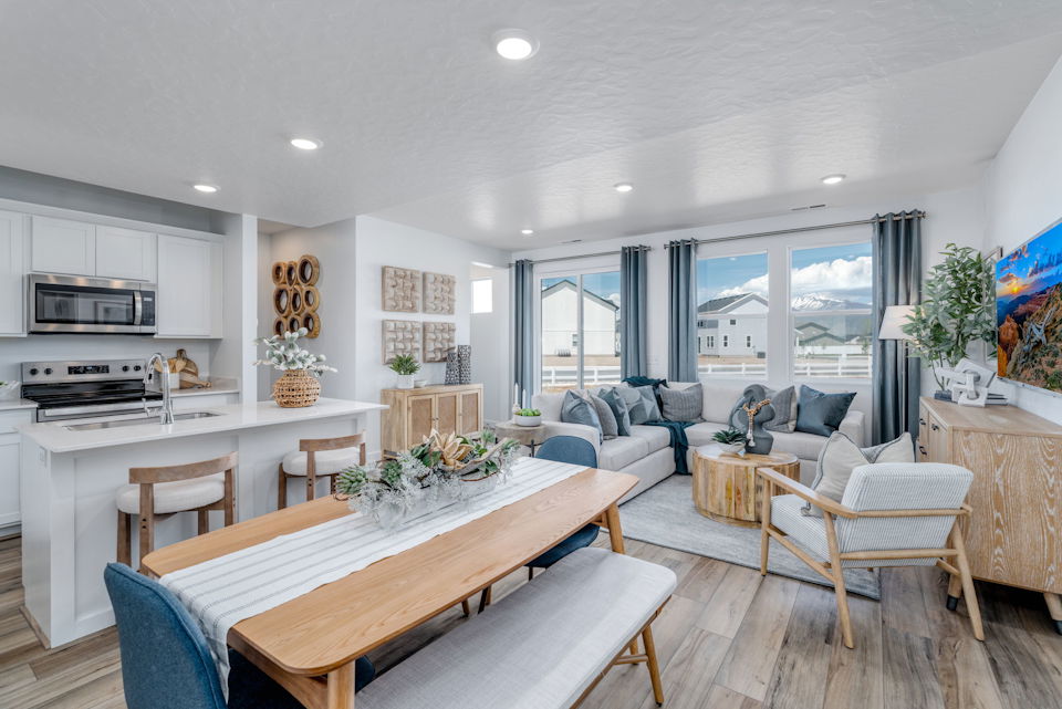A large living room with a dining table and chairs.