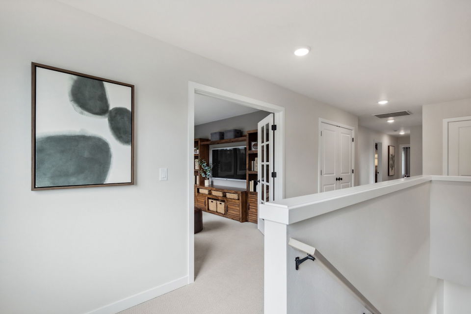 A white room with a fireplace.