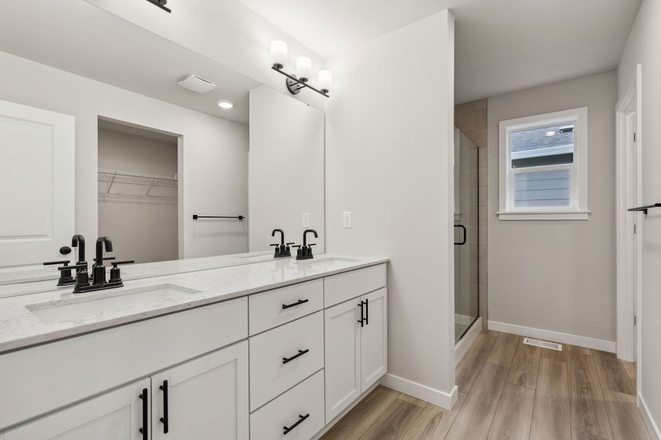 A bathroom with white cabinets.