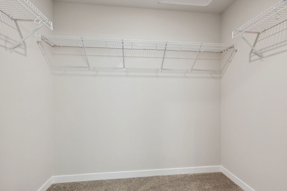 A white wall with a metal railing.