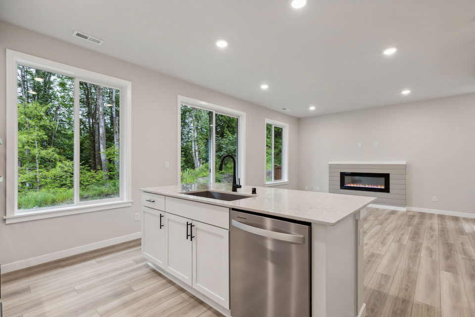 A kitchen with a stove and a microwave.