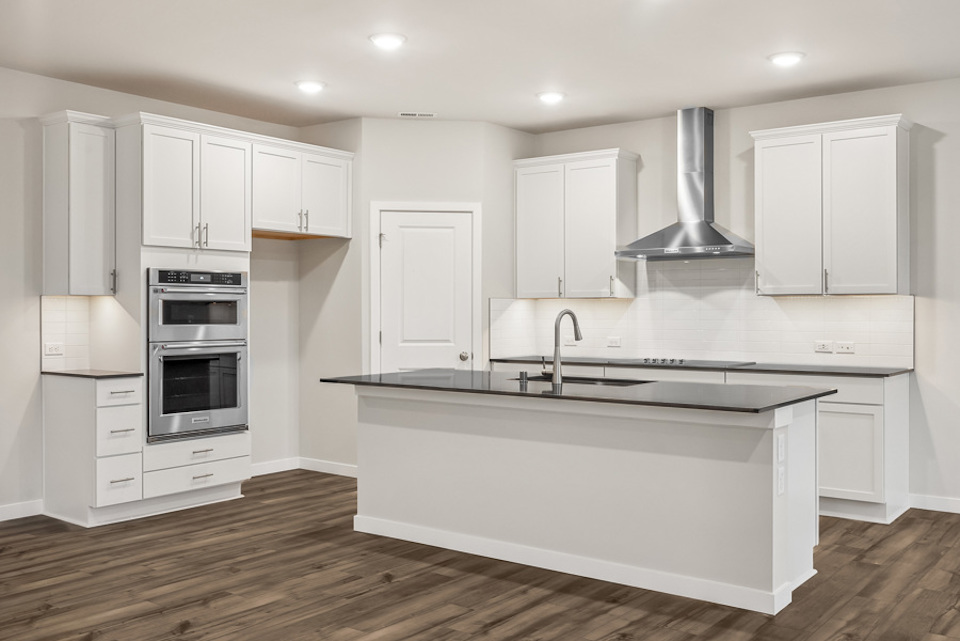 A kitchen with white cabinets.