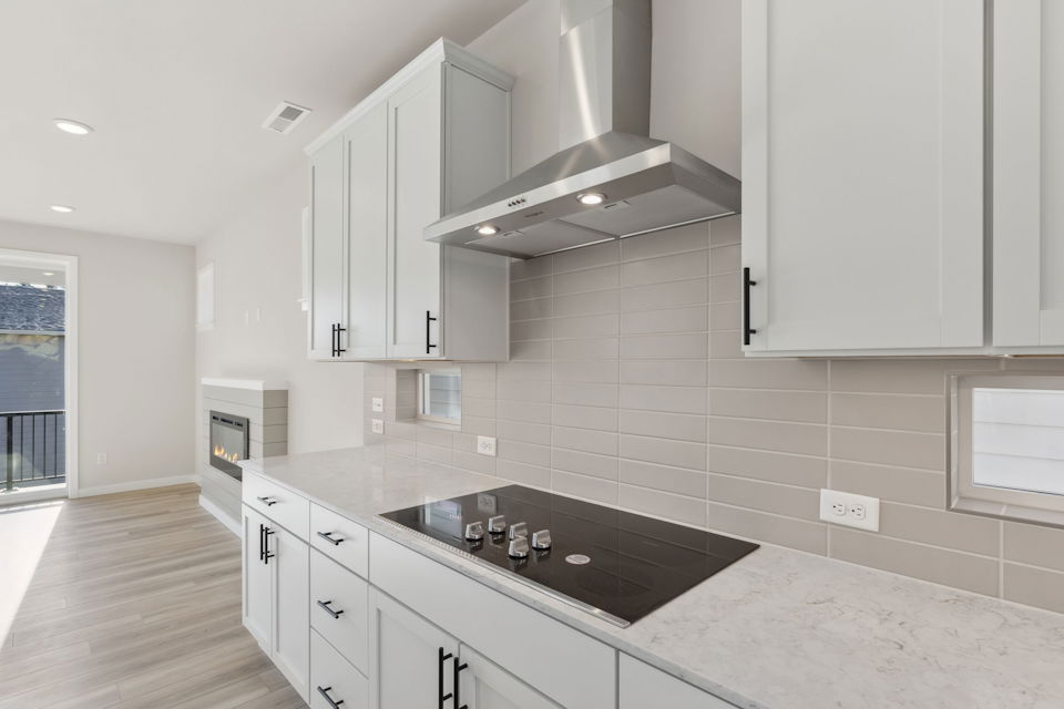 A kitchen with white cabinets.