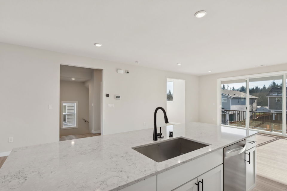 A kitchen with a sink and a large window.