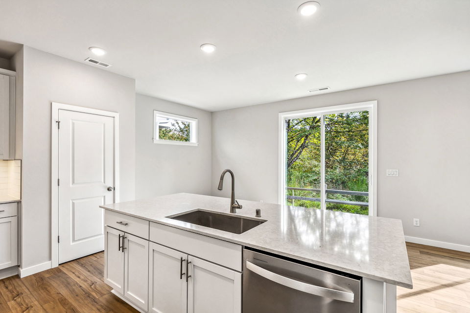 A kitchen with a marble countertop.