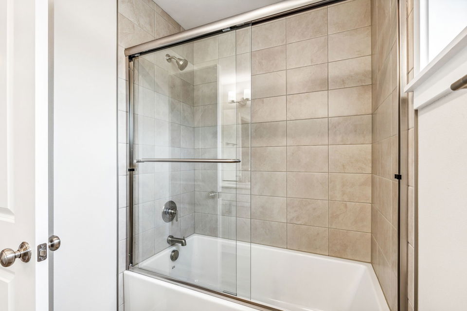 A shower with a glass door.