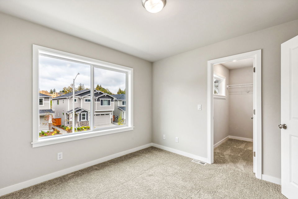 A room with a window and a door.