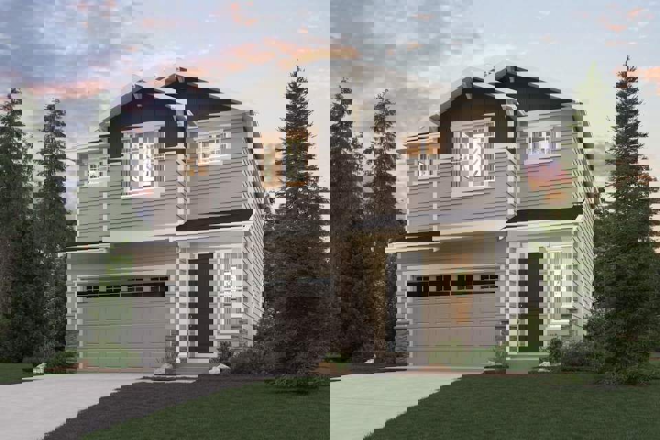 A house with a garage and trees around it.