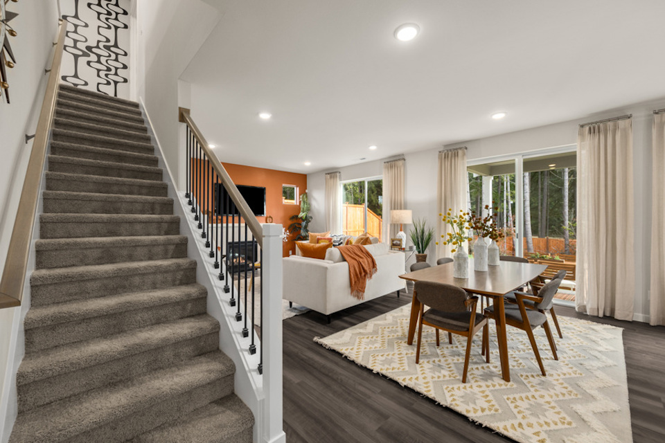 A large living room with a staircase.