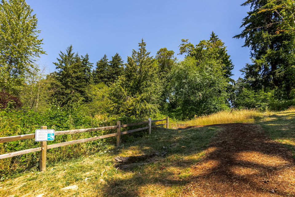 A wooden fence in a field.