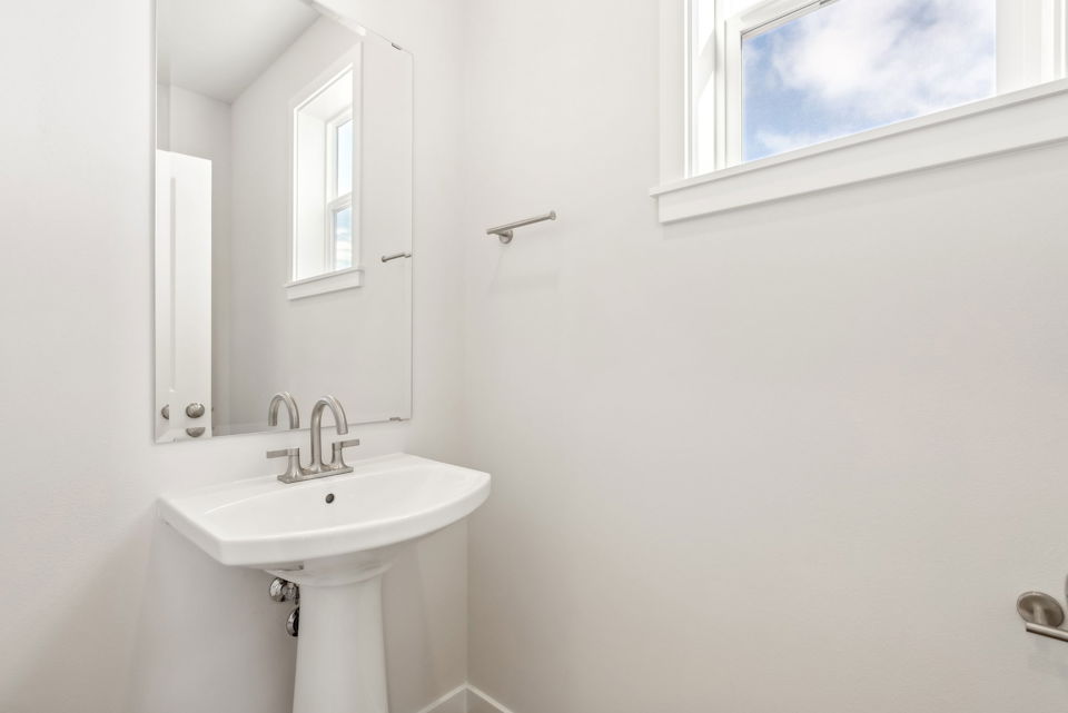 A bathroom with a sink and mirror.