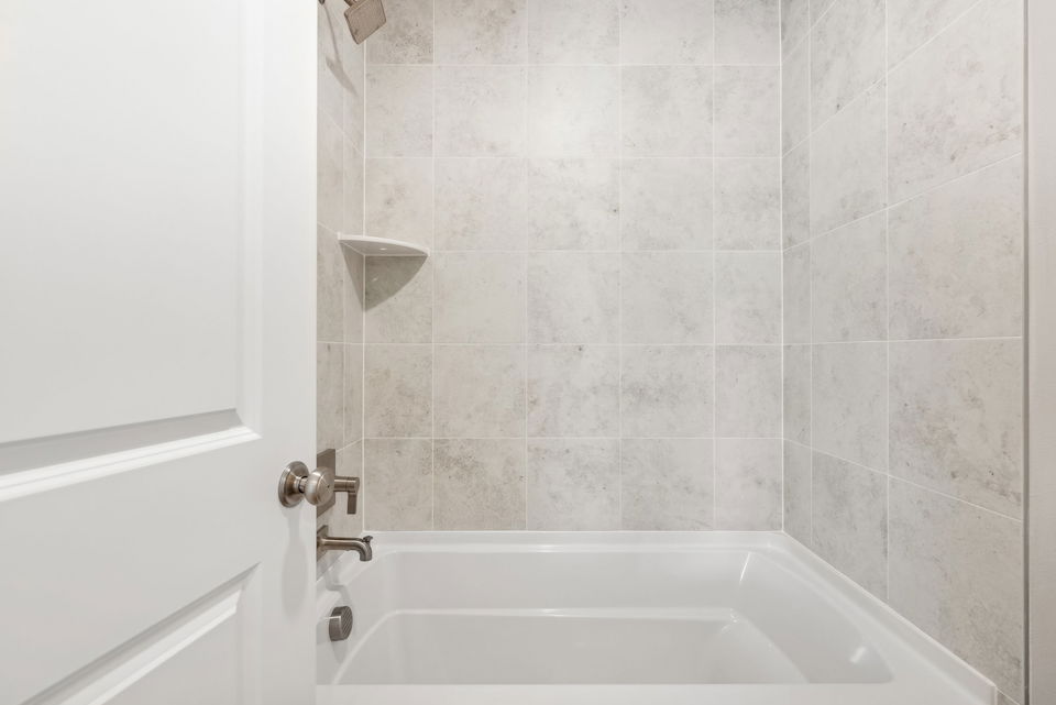 A bathtub in a bathroom.