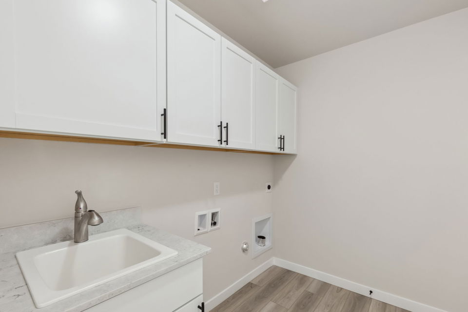 A white kitchen with white cabinets.