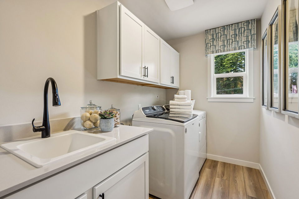A kitchen with white cabinets.