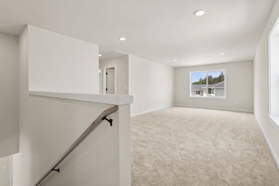 A room with a white wall and a window.