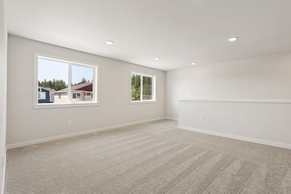 A room with a window and a carpet.