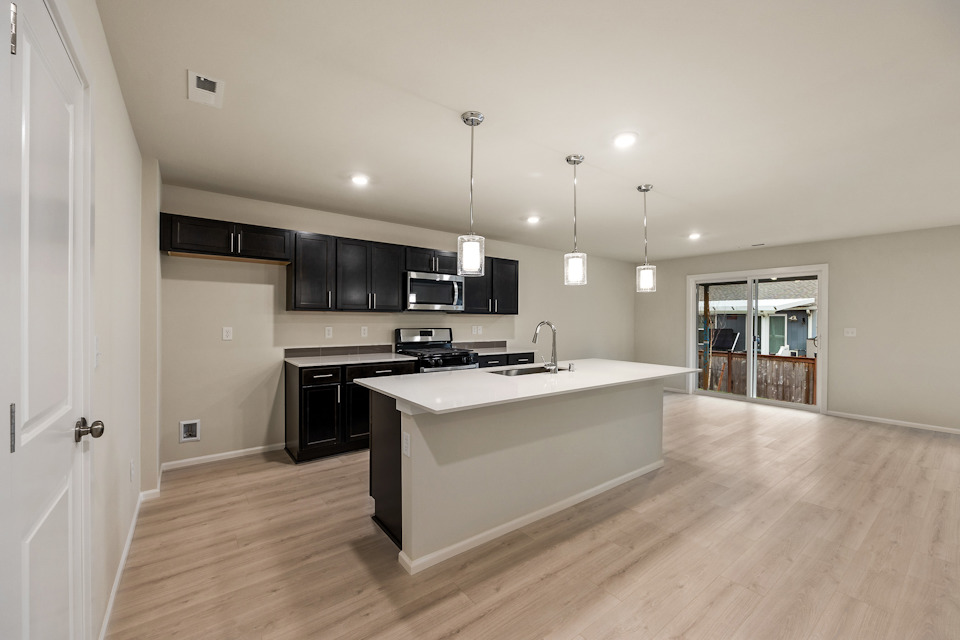 A kitchen with a large white counter.