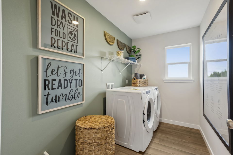 A room with a washer and dryer.