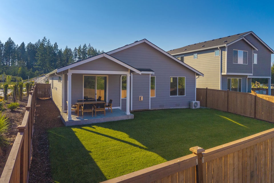 A house with a yard and a fence.