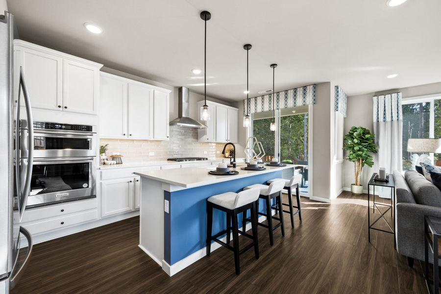 A kitchen with white cabinets.