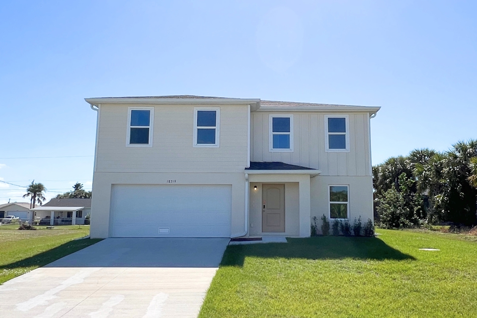 A white house with a driveway.