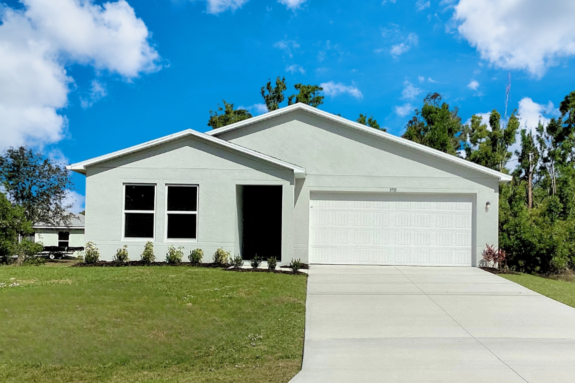 A white house with a garage.