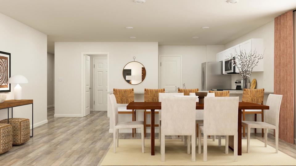 A dining room with a large table.