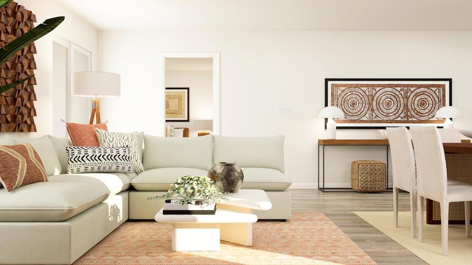 A living room with a white couch and a table.