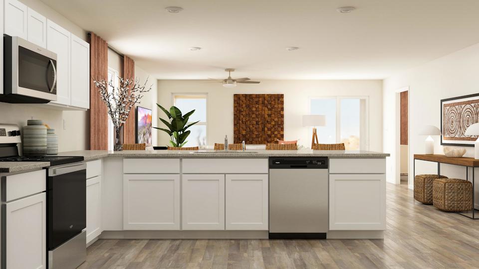 A kitchen with white cabinets.