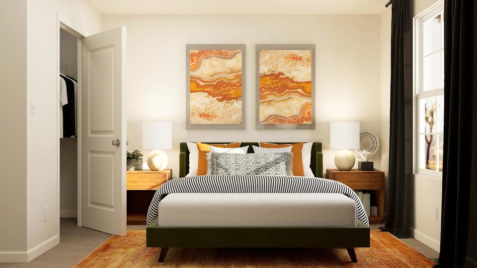 A bedroom with a bed and a lamp.