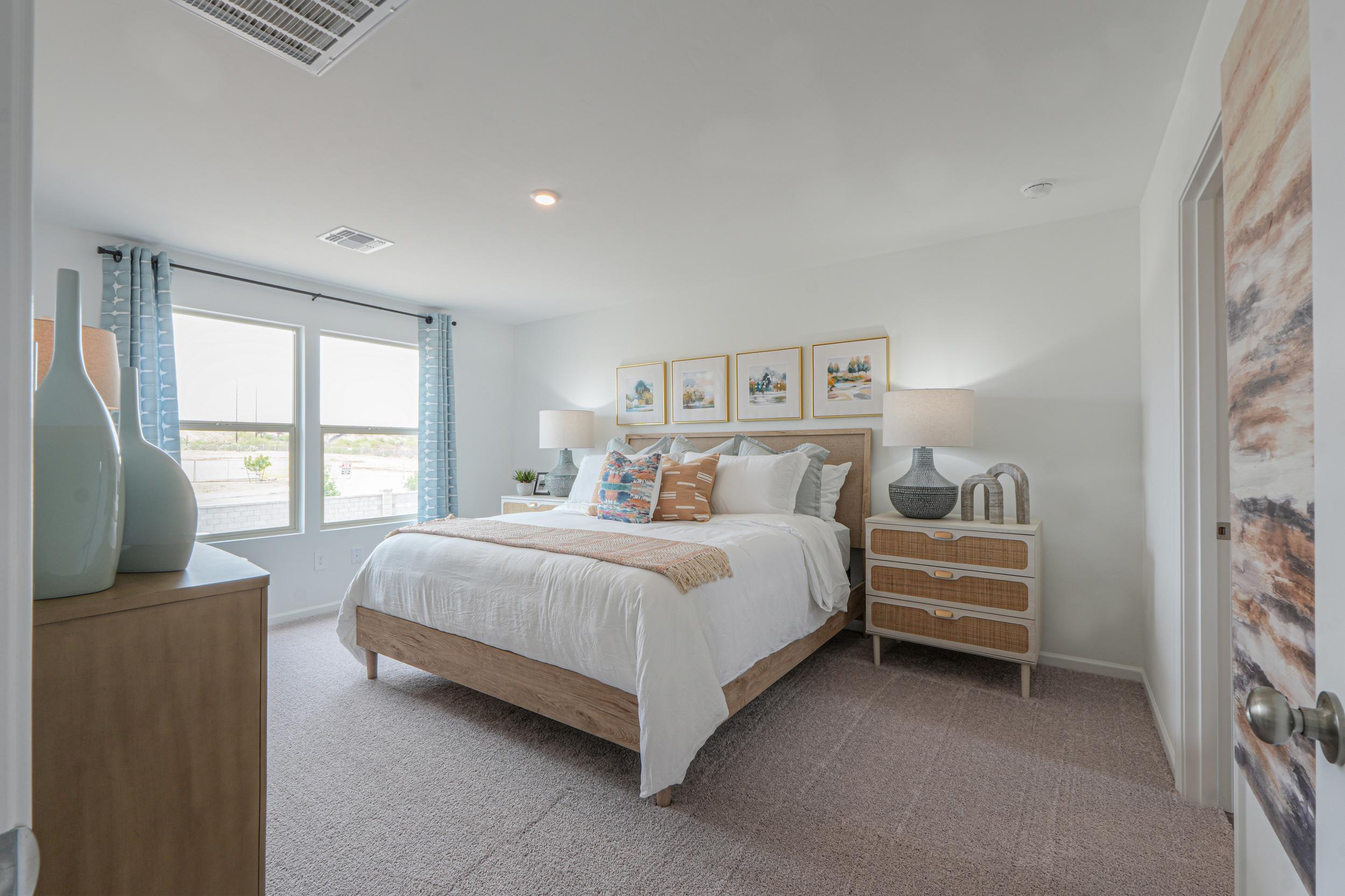A bedroom with a bed and a window.