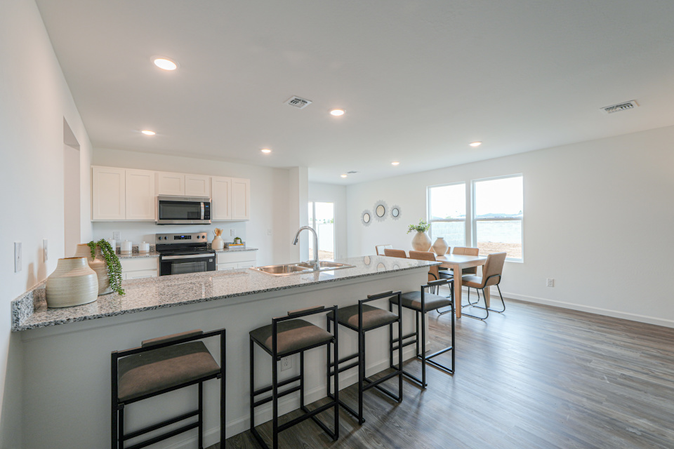 A kitchen with a marble island.