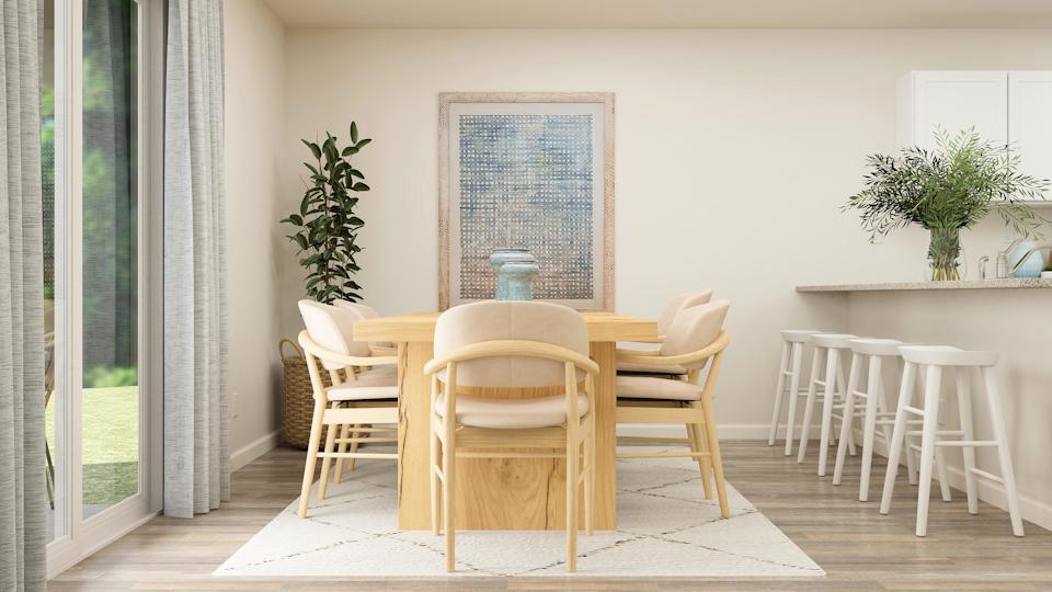 A dining room table with chairs around it.