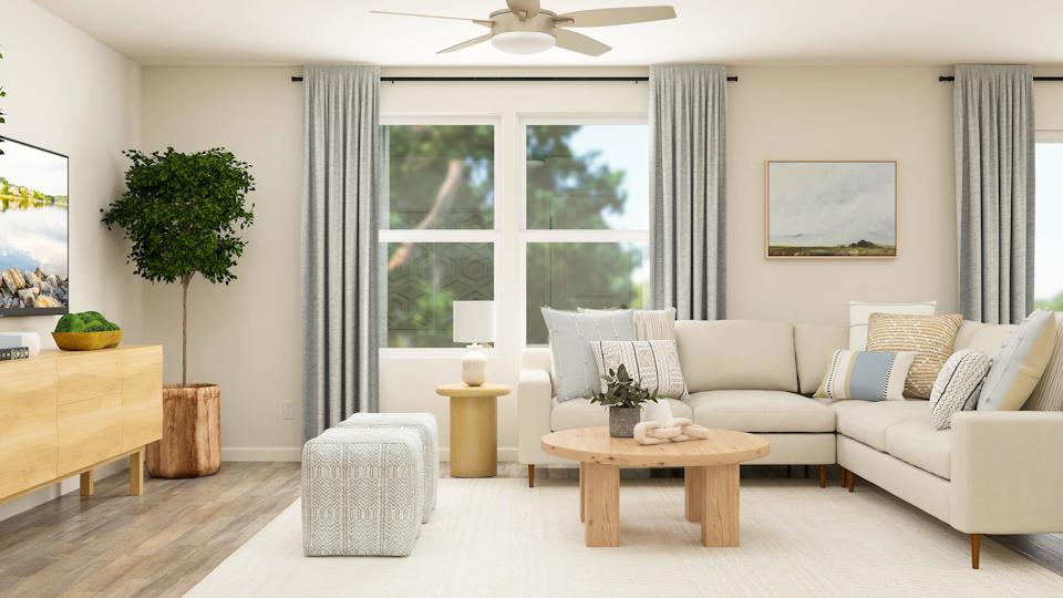 A living room with a white couch and a table.