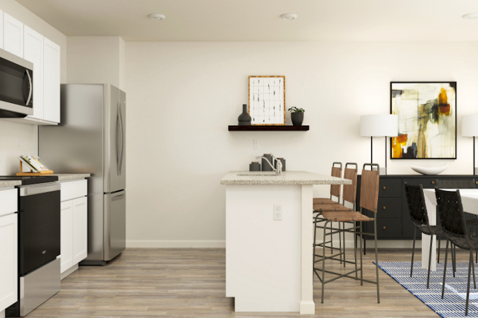 A kitchen with a table and chairs.