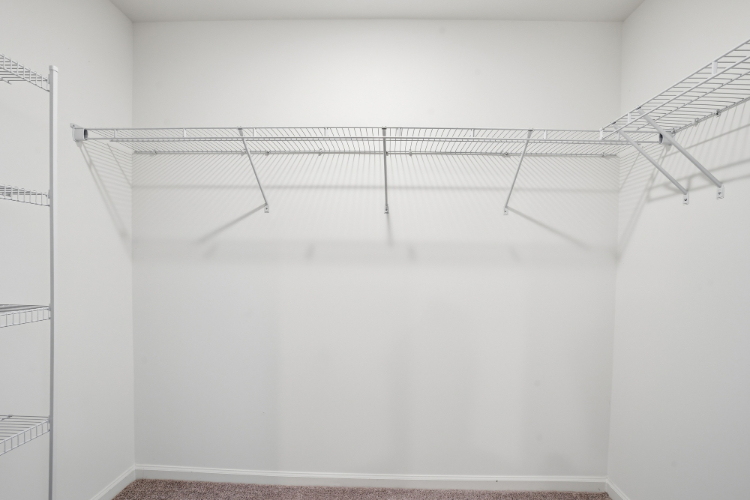 A white room with a metal railing.