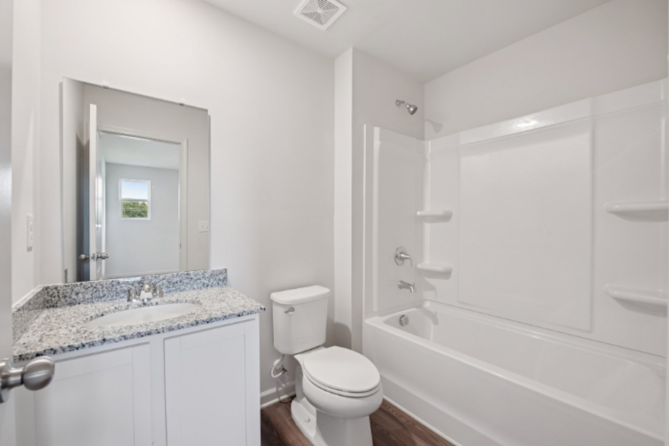 A bathroom with a tub toilet and sink.