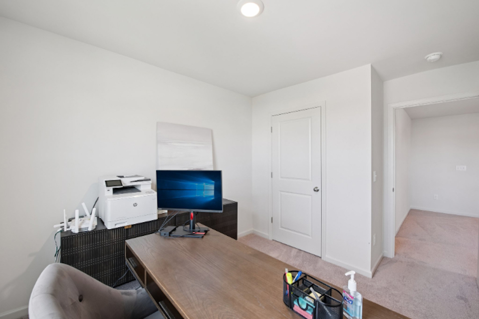 A room with a table and a tv and a chair.