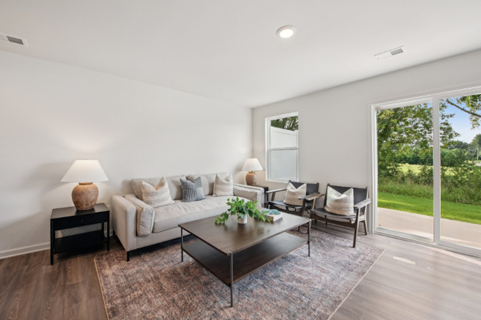 A living room with a large glass door.