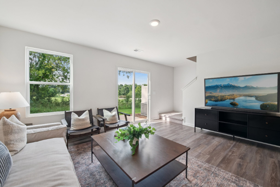 A living room with a large television.