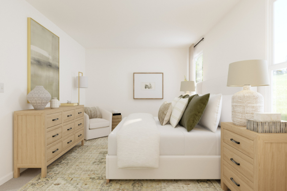 A living room with a white couch and a white table.